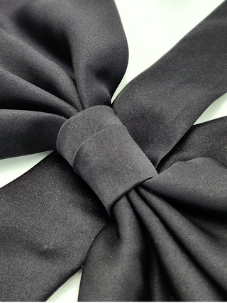 Closeup detail of black silk charmeuse bow