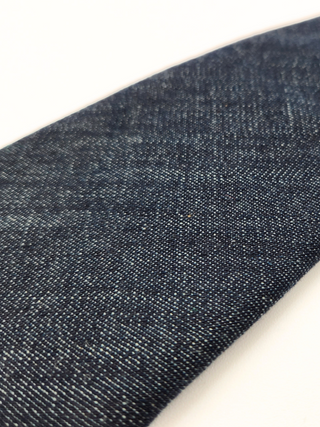 Close-up of blue denim fabric on a white background