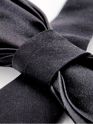 Close-up of a black bow tie on a white background