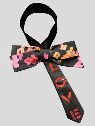 Black bow with floral print and the word Love hand painted