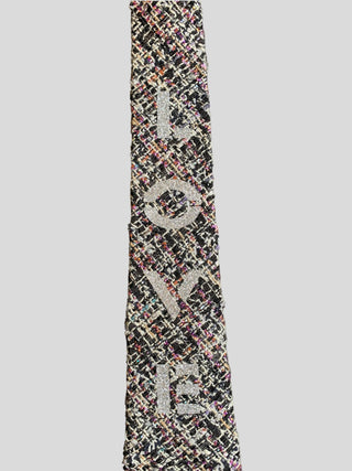 Closeup of metallic tweed necktie with the word Love hand painted in silver