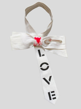 White bowtie with the word Love painted in black, red splatter paint on knot and crystal kilt pin