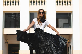 Nancy wearing a Black Jenny Bow with a Nandanie logo shirt and ruffled skirt