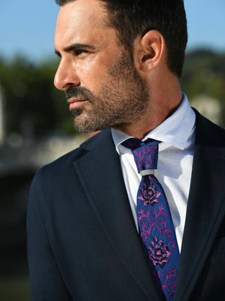 Male model wearing baroque embroidered and beaded necktie with a diamond knot clasp