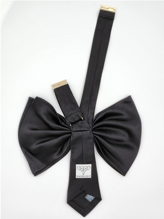 back view of black silk charmeuse bow showing gold adjustable clasp and brand label