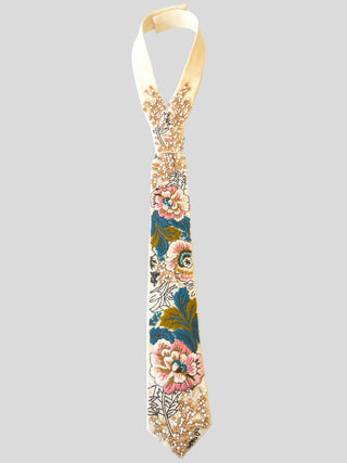 Flat image of ivory tie with pink and blue floral embroidery and crystal embellishments