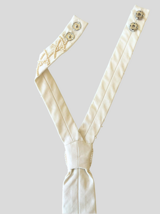 Back view of ivory pearl embroidered tie featuring adjustable snaps